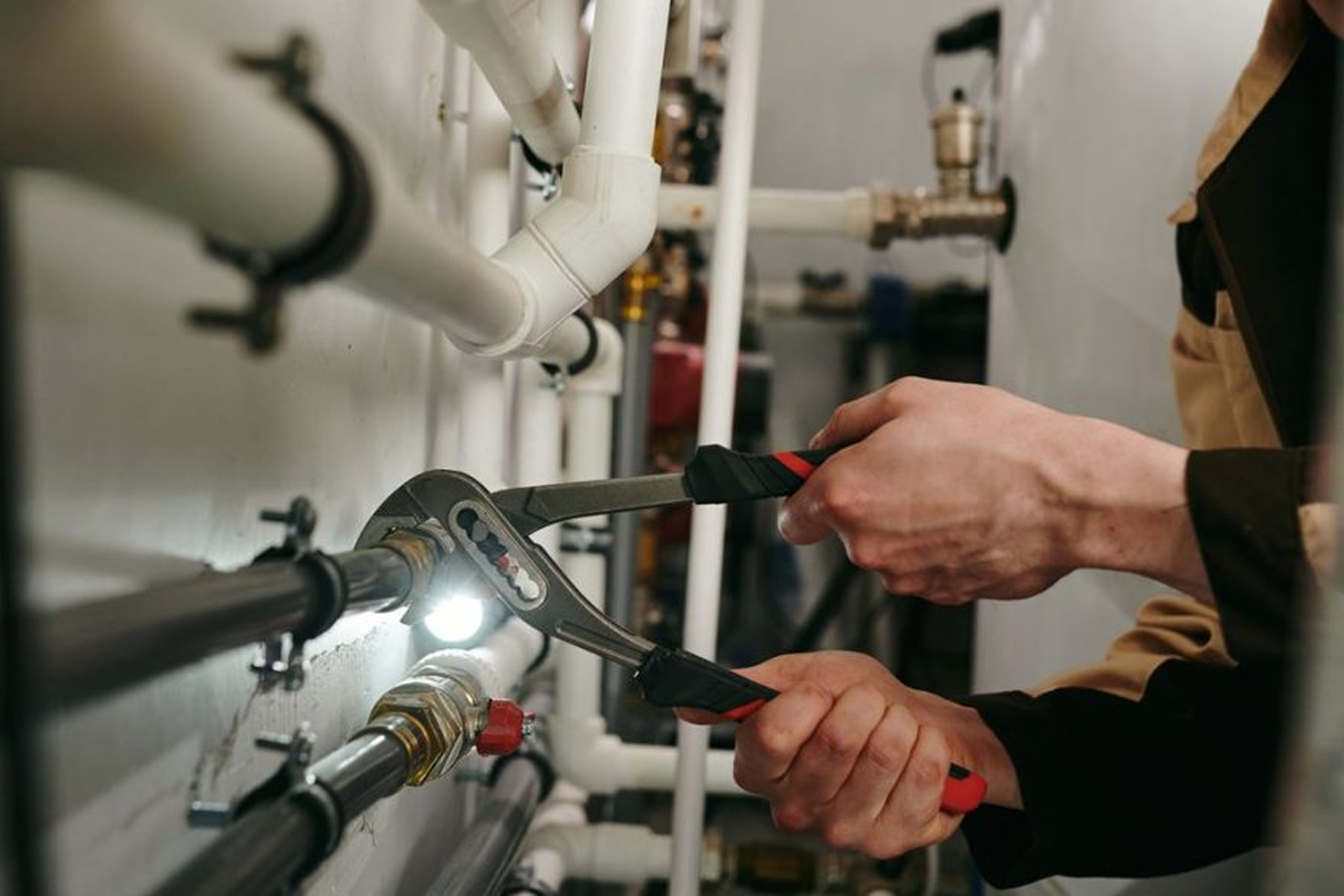 Plumber fixing pipes